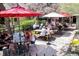 Charming outdoor dining area with umbrellas, picnic tables, and lush greenery for a relaxed atmosphere at 15156 W Baker Pl, Lakewood, CO 80228
