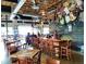 Bright brewery interior with wooden tables, bar, and chalkboard wall at 15156 W Baker Pl, Lakewood, CO 80228