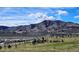 Picturesque view of a mountain range and a neighborhood below at 15156 W Baker Pl, Lakewood, CO 80228