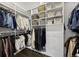 Organized walk-in closet with custom shelving, drawers, and hanging rods for optimal storage and style at 15156 W Baker Pl, Lakewood, CO 80228