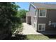 The backyard features a large concrete patio, lawn, mature trees and privacy fence at 2517 S Genoa St, Aurora, CO 80013