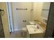 A neutral-toned bathroom featuring a toilet, sink, and plenty of counter space at 2517 S Genoa St, Aurora, CO 80013