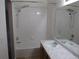 Bathroom with white tile, shower head, marble counter and sink at 2517 S Genoa St, Aurora, CO 80013