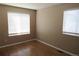 Cozy bedroom with hardwood flooring, two windows that let in natural light and neutral-colored walls at 2517 S Genoa St, Aurora, CO 80013