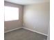 Neutral bedroom featuring a plush carpet, a large window, and neutral walls that create a serene space at 2517 S Genoa St, Aurora, CO 80013