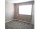 This is a cozy bedroom featuring neutral walls, plush carpeting, and a bright window at 2517 S Genoa St, Aurora, CO 80013