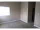Bedroom with plush carpet and a window providing natural light; freshly painted neutral walls and white trim at 2517 S Genoa St, Aurora, CO 80013