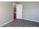 Bedroom with plush carpet and a view into the ensuite; freshly painted neutral walls and white trim at 2517 S Genoa St, Aurora, CO 80013