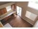 High-angle shot of dining area featuring wooden floors, a glass sliding door, and built-in cabinetry at 2517 S Genoa St, Aurora, CO 80013