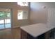 Dining area with wooden floors, a glass sliding door, and a window offering abundant natural light at 2517 S Genoa St, Aurora, CO 80013