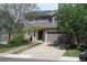 Charming home exterior with mature landscaping, a two car garage and solar panels at 2517 S Genoa St, Aurora, CO 80013
