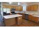 Bright kitchen featuring stainless steel appliances, wooden cabinetry, and an island with a white countertop at 2517 S Genoa St, Aurora, CO 80013