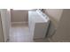 Convenient laundry area with white appliances and tile flooring at 2517 S Genoa St, Aurora, CO 80013