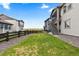Spacious backyard with a lush green lawn, fence, and view of surrounding homes at 3636 Sublime Ct, Castle Rock, CO 80108