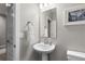 Charming bathroom with a pedestal sink, stylish mirror, and decorative accents at 3636 Sublime Ct, Castle Rock, CO 80108