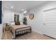 Bright bedroom featuring a comfortable bed, side table, and large clock on the wall at 3636 Sublime Ct, Castle Rock, CO 80108