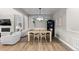 Bright dining area featuring a modern pendant light, wooden table, and open living space at 3636 Sublime Ct, Castle Rock, CO 80108