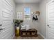 Cozy entryway featuring a wooden bench with storage baskets, decor, and bright window at 3636 Sublime Ct, Castle Rock, CO 80108