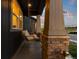 Inviting front porch features a cozy swing and stone pillars, perfect for relaxation at 3636 Sublime Ct, Castle Rock, CO 80108