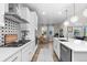 Bright modern kitchen featuring stainless steel appliances, white cabinetry, and eye-catching backsplash at 3636 Sublime Ct, Castle Rock, CO 80108