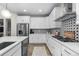 Well-equipped kitchen with white cabinetry, stainless steel appliances, and modern backsplash at 3636 Sublime Ct, Castle Rock, CO 80108