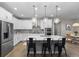 Stylish kitchen featuring white cabinets, stainless steel appliances, and a large center island at 3636 Sublime Ct, Castle Rock, CO 80108