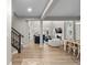 Open-concept living space with hardwood floors, staircase, and seamless flow to dining area at 3636 Sublime Ct, Castle Rock, CO 80108