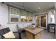 Covered deck showing the sliding door entry, fire pit, and seating area at 3636 Sublime Ct, Castle Rock, CO 80108