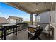 View of the covered deck featuring a grill, seating, and outdoor lighting at 3636 Sublime Ct, Castle Rock, CO 80108