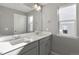 Bright bathroom featuring a double sink vanity with quartz counters at 27746 E Byers Pl, Aurora, CO 80018