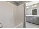 Bathroom featuring tiled walls, a soaking tub, and a view of the vanity at 27746 E Byers Pl, Aurora, CO 80018