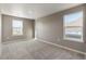 Spacious bedroom features two windows, neutral walls, and neutral carpet at 27746 E Byers Pl, Aurora, CO 80018