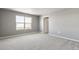 Bright bedroom featuring neutral carpet, large windows, and an ensuite bathroom at 27746 E Byers Pl, Aurora, CO 80018