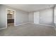 Spacious bedroom featuring neutral walls, carpet, and an ensuite bathroom and closet at 27746 E Byers Pl, Aurora, CO 80018