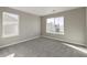 Bedroom featuring two windows, neutral walls, and neutral carpet at 27746 E Byers Pl, Aurora, CO 80018