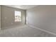 Bedroom with neutral walls and carpet and a large window at 27746 E Byers Pl, Aurora, CO 80018
