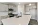 Bright kitchen with island, stainless steel appliances, and gray cabinets at 27746 E Byers Pl, Aurora, CO 80018