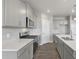 Close-up of the kitchen with stainless steel oven and sink with gray backsplash and cabinets at 27746 E Byers Pl, Aurora, CO 80018