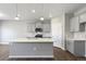 Open kitchen with a center island, stainless steel appliances, and pendant lighting at 27746 E Byers Pl, Aurora, CO 80018