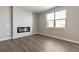 Open concept living space featuring modern floors and a fireplace at 27746 E Byers Pl, Aurora, CO 80018