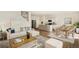 Bright and spacious open-concept living space with a combined living, dining, and kitchen area at 27746 E Byers Pl, Aurora, CO 80018