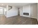 Open concept living space featuring modern floors and a fireplace at 27746 E Byers Pl, Aurora, CO 80018