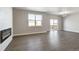 Bright living room featuring hardwood floors, fireplace, and a sliding door to the deck at 27746 E Byers Pl, Aurora, CO 80018