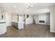 Open concept space with kitchen, stairway, fireplace and hardwood floors at 27746 E Byers Pl, Aurora, CO 80018
