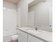 Bright bathroom features a shower-tub combo with white tiling and neutral-colored vanity with a modern faucet and ample counter space at 48280 Shetland Dr, Bennett, CO 80102