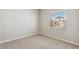 Bright bedroom with soft carpeting, a large window, and neutral walls at 48280 Shetland Dr, Bennett, CO 80102