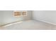 Well-lit bedroom with neutral carpeting and a view of the backyard at 48280 Shetland Dr, Bennett, CO 80102