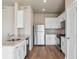 Modern kitchen boasts stainless steel appliances, granite countertops, and ample cabinet space at 48280 Shetland Dr, Bennett, CO 80102