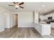 Open-concept living room featuring hardwood floors and recessed lighting at 48280 Shetland Dr, Bennett, CO 80102