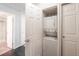 A well-appointed laundry closet features a stacked washer and dryer unit at 4779 White Rock Cir # B, Boulder, CO 80301